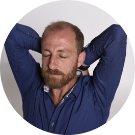 A smiling male with both his palms facing downwards performing breathing exercise