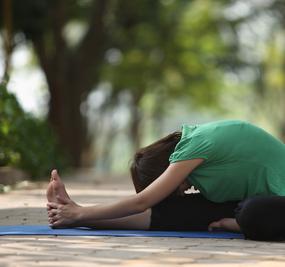 Yoga-Forward-bend-girl-touching-feet