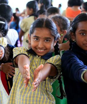 social impact education - school students extending hands