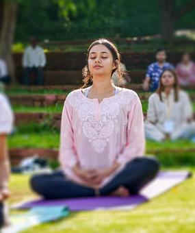 group meditation in lawn girl smiling at blr ashram