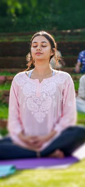 group meditation in lawn girl smiling at blr ashram